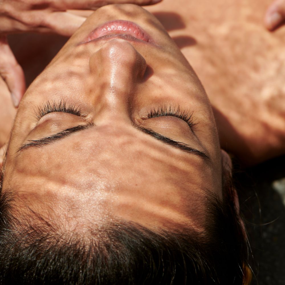 Client laying down to receive a treatment using osmosis beauty wellness skincare collection 